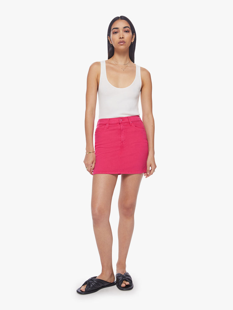 Front view of a woman high waisted mini skirt with side slit pockets and a playfully short hemline in a hot pink hue.