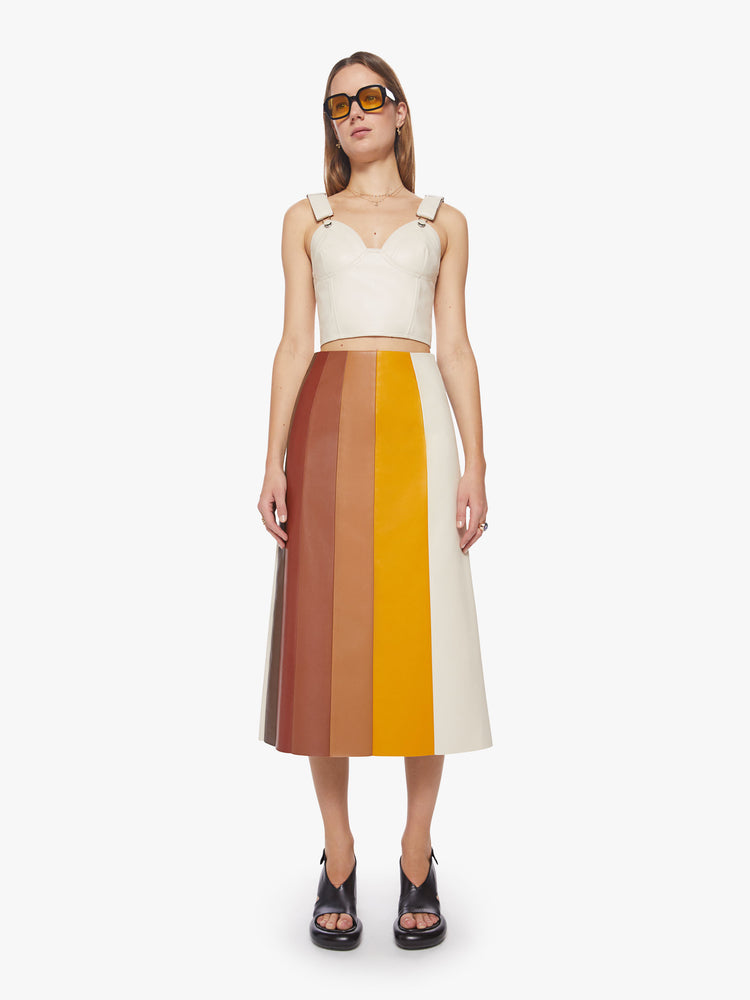 Front view of a woman colorblocked midi skirt with a high rise, loose fit and a calf-grazing hem in a faux leather.