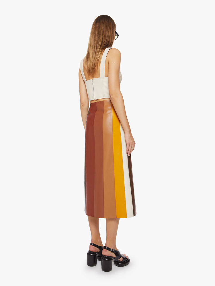 Back view of a woman colorblocked midi skirt with a high rise, loose fit and a calf-grazing hem in a faux leather.