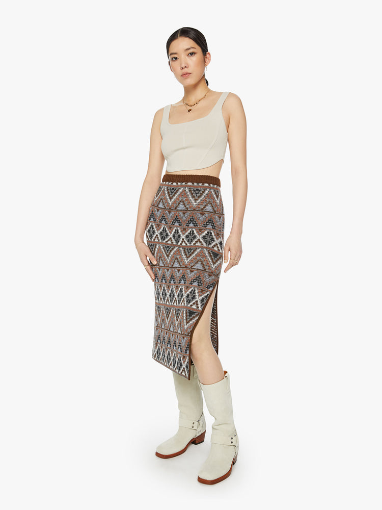 Front view of a woman knit midi skirt with a high-rise, thigh-high side slit and a straight fit in metallic shades of brown, grey and white.
