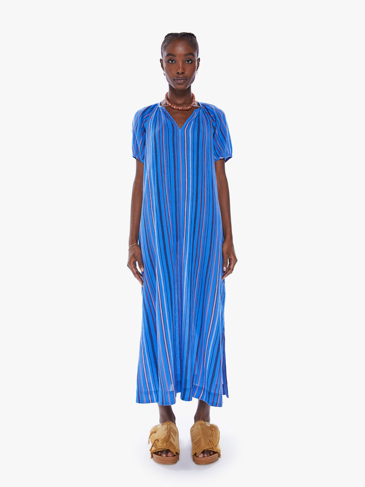 Front view of a woman maxi dress with a V-neck, short puffed sleeves, side slits in a blue stripe pattern.