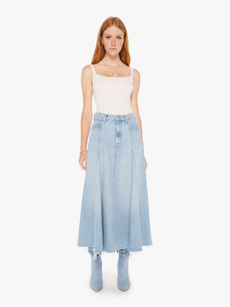 Front view of a womens light blue wash denim skirt featuring a high rise and frayed hem.
