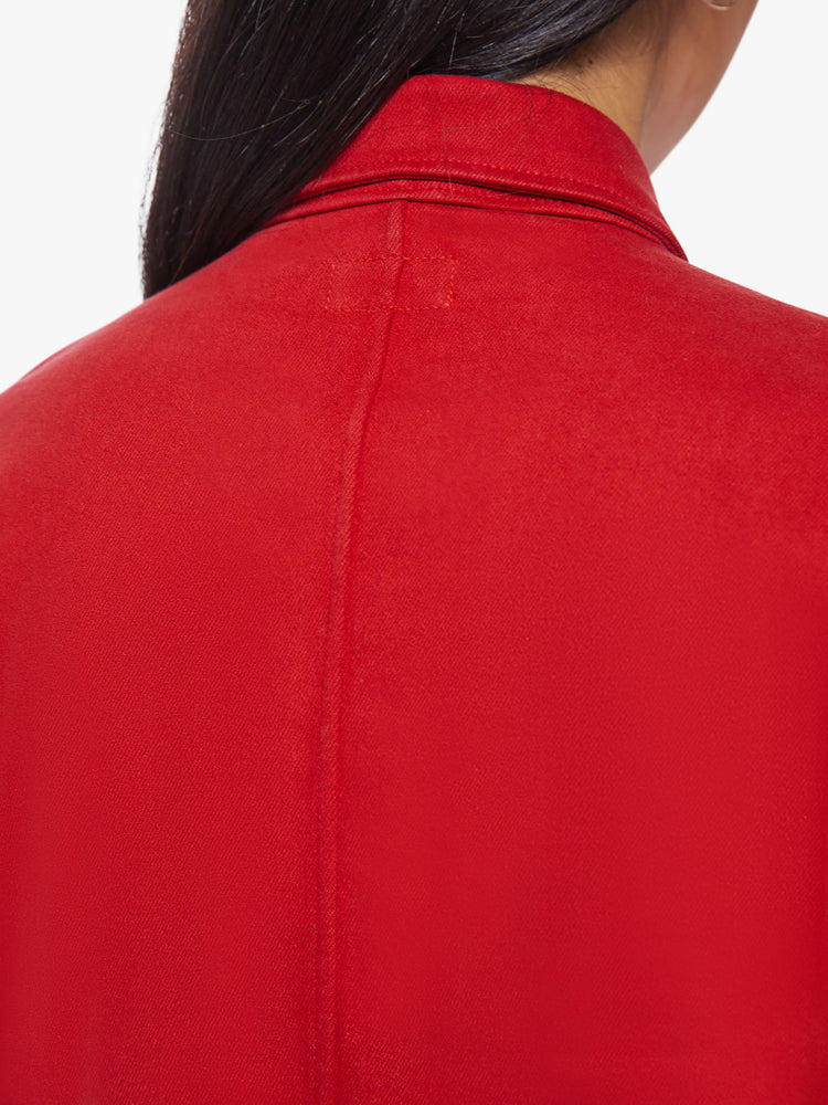 Back close up view of a woman red mini shirt dress with long sleeves, a collared neck, buttons down the front and a tied belt at the waist.