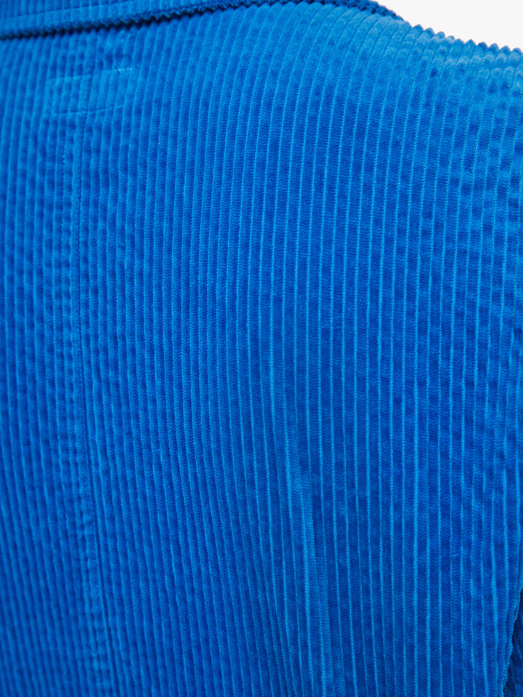 Close up back view of a woman zip-up jumpsuit with a collared neck, long sleeves, patch pockets and an ankle-length inseam in a bright blue corduroy.