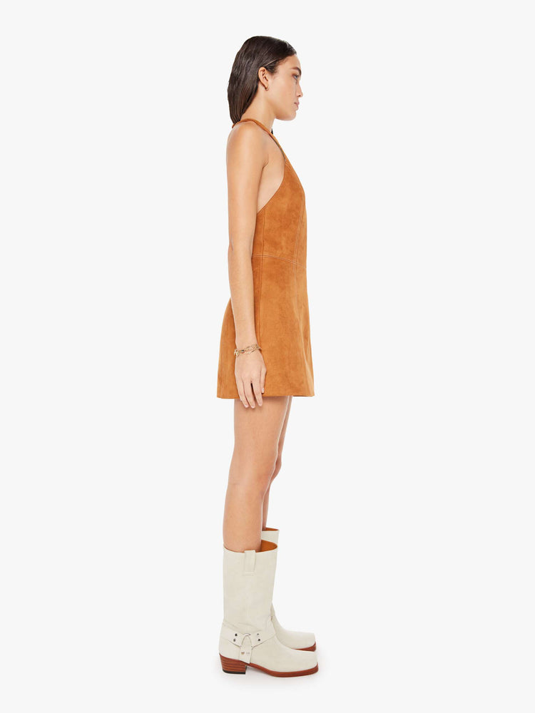 Side view of a womens brown faux suede dress featuring a halter neck.