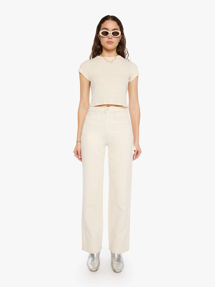 Front view of a woman in super high-waisted pants with a wide leg, zip fly, oversized patches at the knees, a hammer loop, 32-inch inseam and a clean hem. 