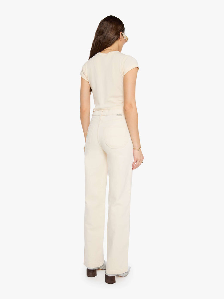 Back view of a woman in super high-waisted pants with a wide leg, zip fly, oversized patches at the knees, a hammer loop, 32-inch inseam and a clean hem. 