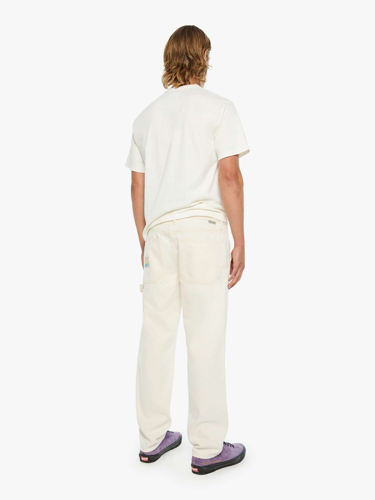 Back view of a classic pant with slit pockets, a zip fly, workwear-inspired patches at the knees, a hammer loop and a loose leg.