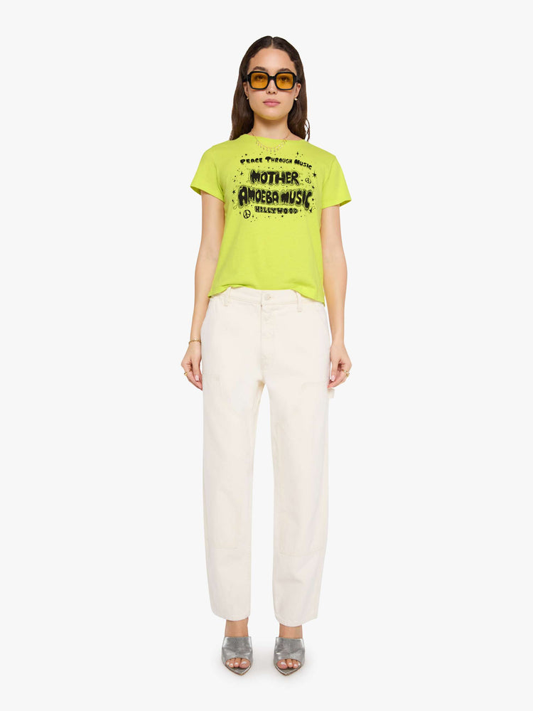 Front full body view of a woman in a lime green top features MOTHER's spin on the classic Amoeba Music logo in black on the front.