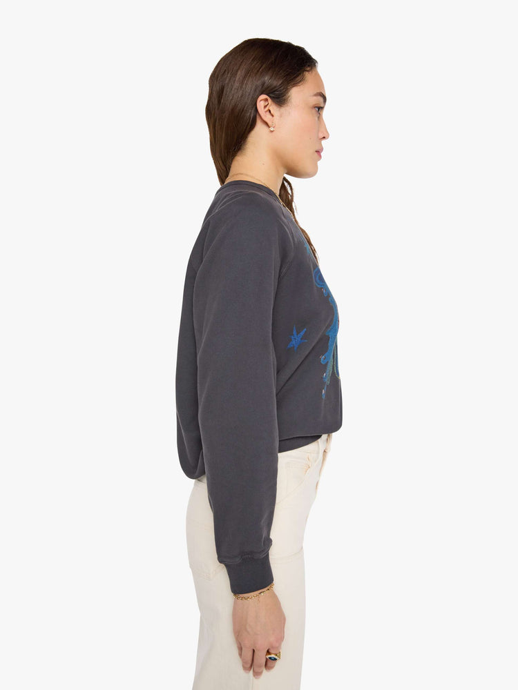 Side view of woman faded black, the sweatshirt features a colorful Amoeba Music graphic and MOTHER's name on the front.