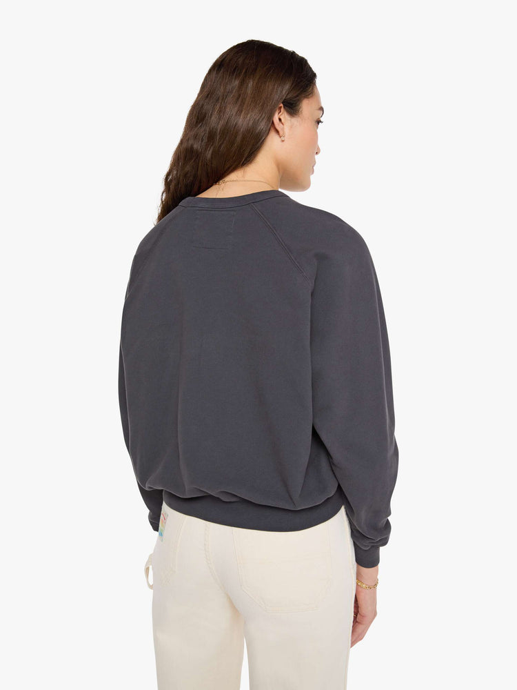 Back view of woman faded black, the sweatshirt features a colorful Amoeba Music graphic and MOTHER's name on the front.