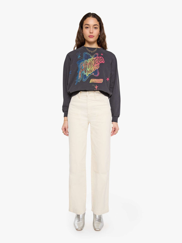 Front full body view of woman faded black, the sweatshirt features a colorful Amoeba Music graphic and MOTHER's name on the front.