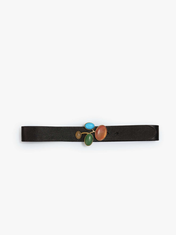 Flat view of a black leather belt with a chunky metal buckle detailed with turquoise, amber, green and pale yellow stones.