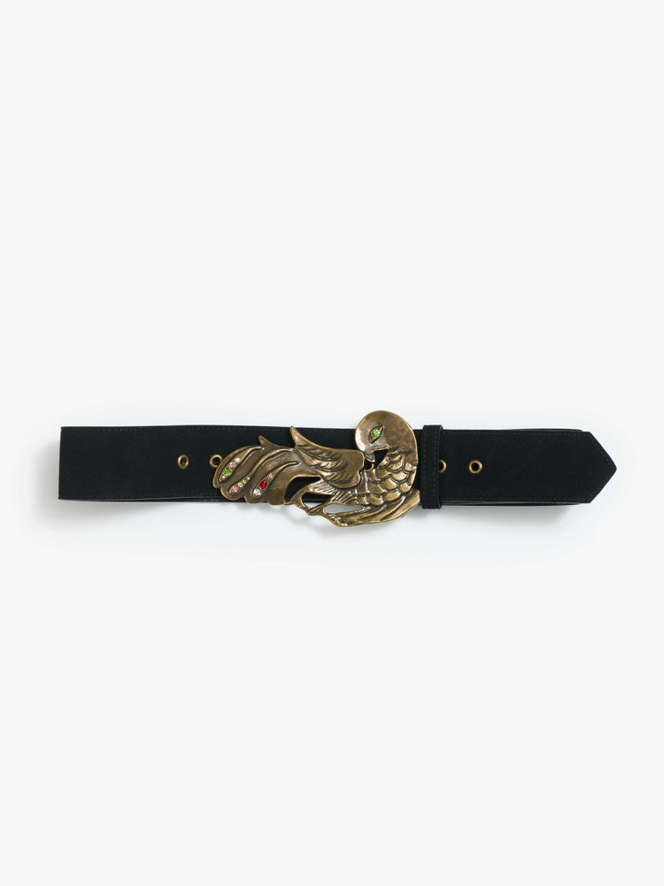 Front view of a wide leather belt designed in black suede with an oversized antique brass buckle detailed with colored gemstones.