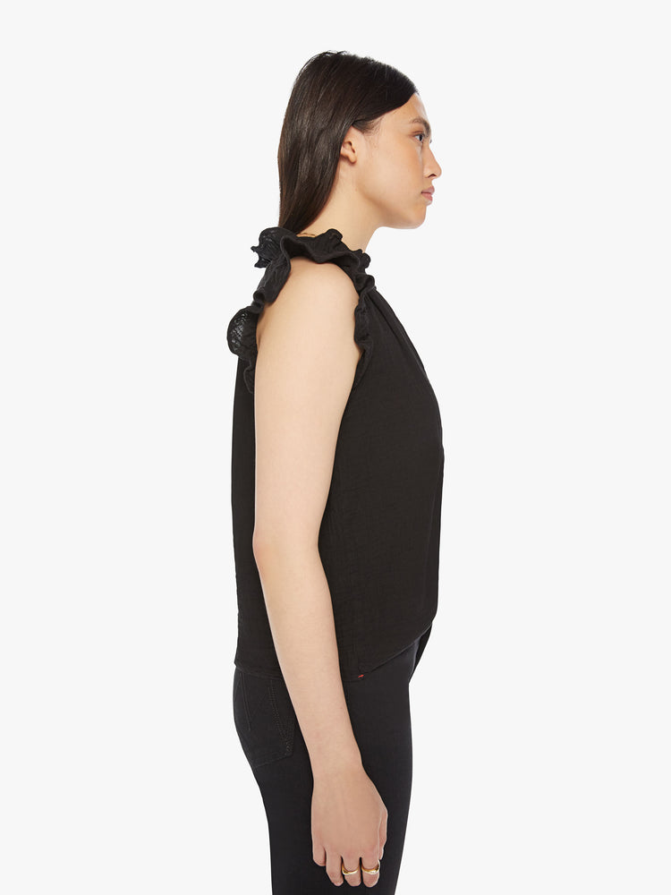 Side view of a black V-neck top with short, ruffled sleeves and a boxy fit.