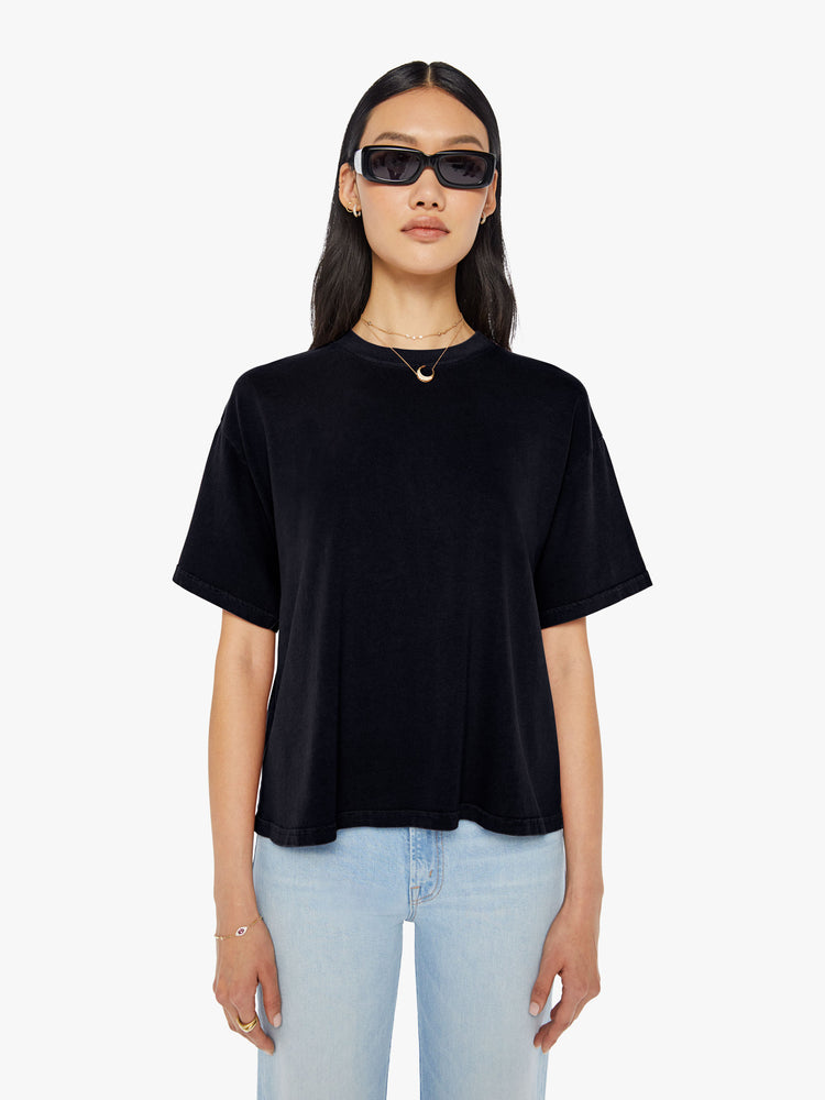 A front view of a woman wearing a black oversized tee.