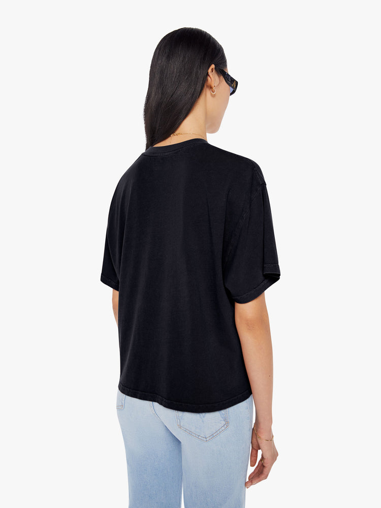 Back  view of a woman wearing a black oversized tee.