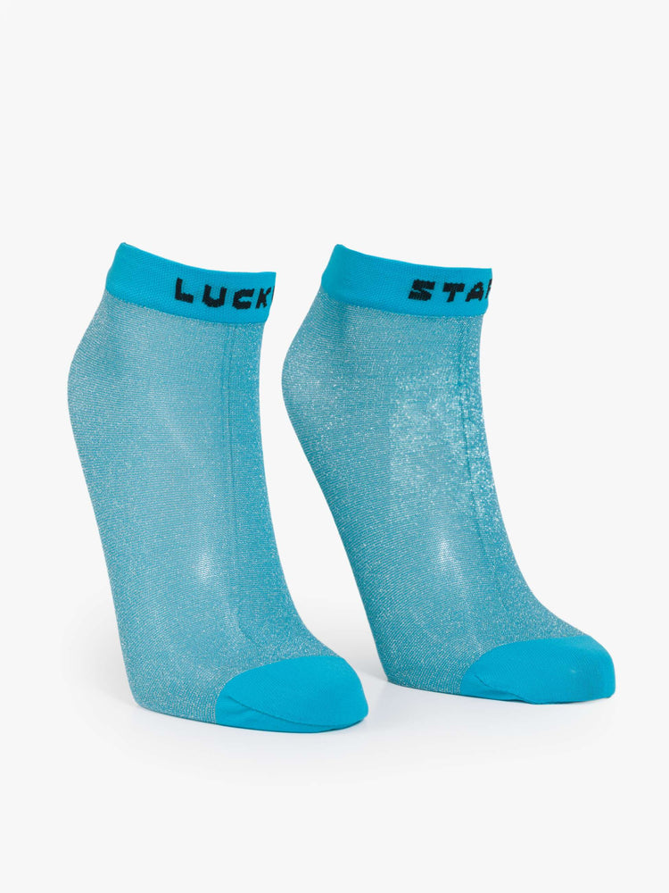 Flat view sheer ankle sock designed in glittery turquoise with text in black across the hems.