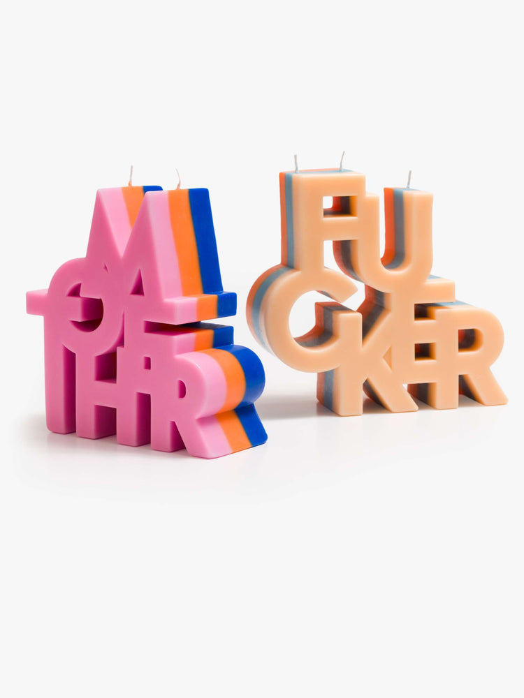 A set of three-wick candle made from a blend of soy wax and beeswax in navy, orange and light pink. 