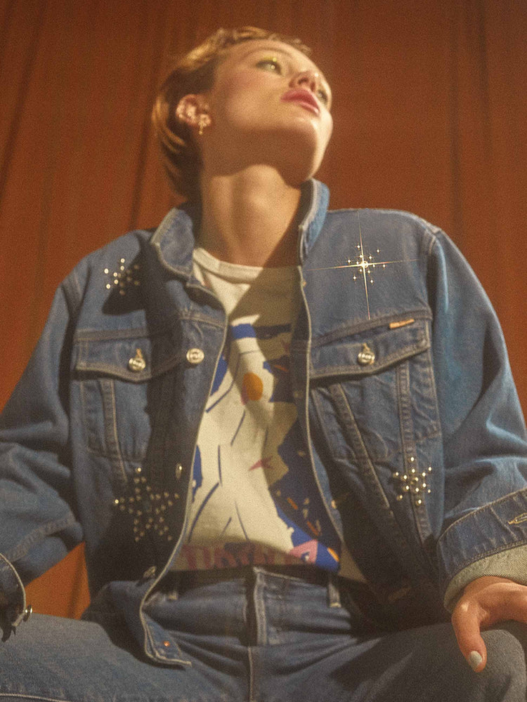 Bowie editorial image of a womans denim jackets with silver studs.