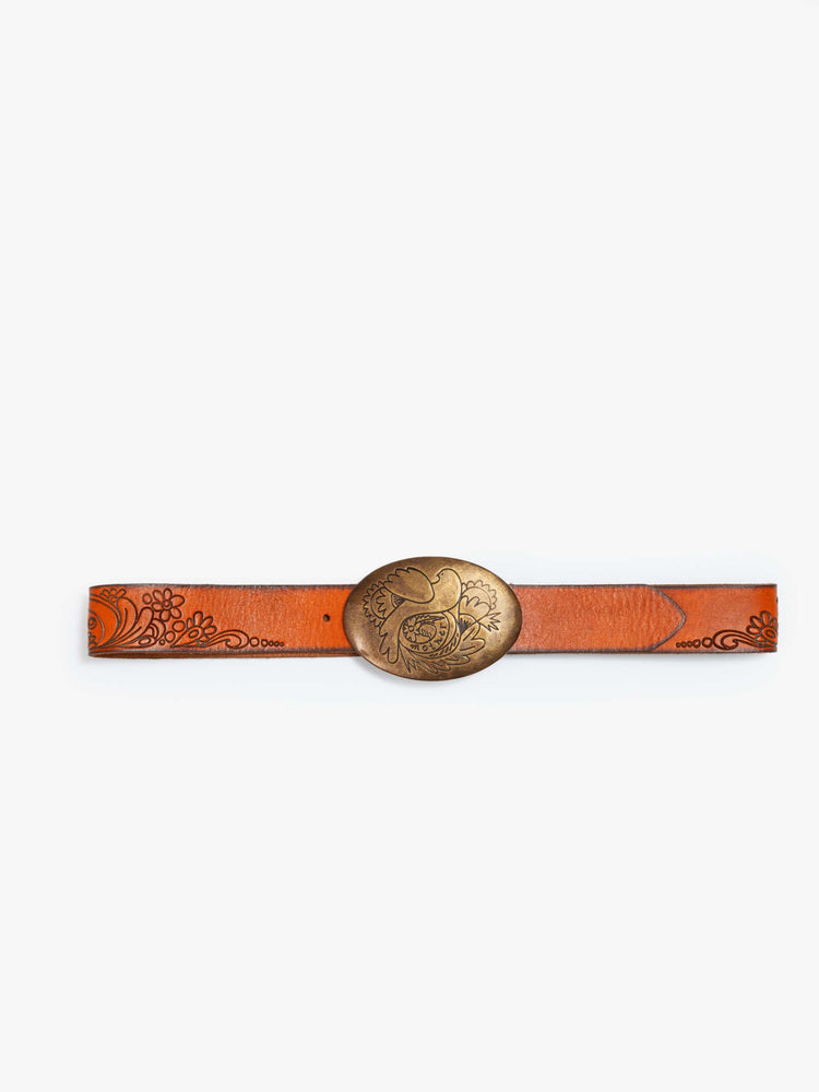 Front view vintage-inspired leather belt with an oversized brass buckle engraved with a bird motif. 