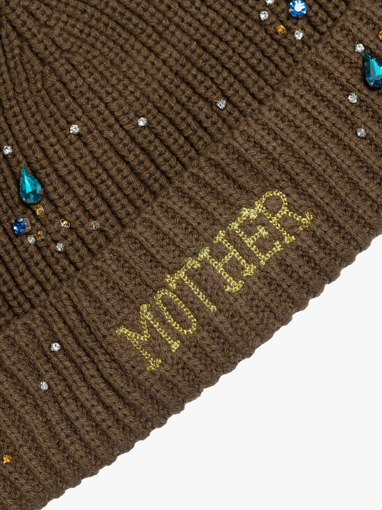 Flat on model view in a brown with MOTHER's name embroidered in gold on the front and beaded details throughout.