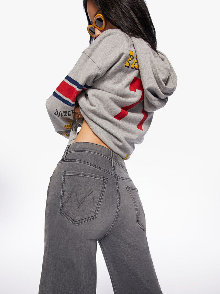 Editorial image of a model wearing grey denim and a grey sweatshirt.