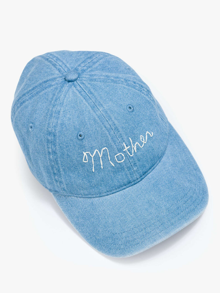 Flat top view of a dad hat designed in light blue denim with MOTHER's name embroidered in white cursive on the front.