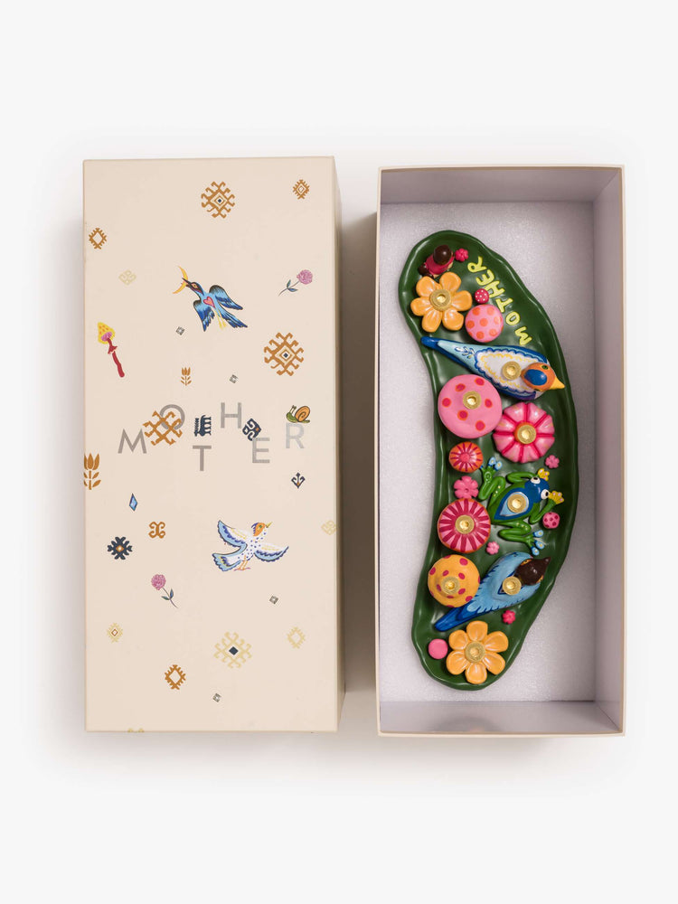 Box view of a Menorah with a colorful scene of mushrooms, flowers and woodland creatures.
