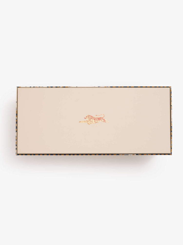 Bottom of the box view of a Menorah with a colorful scene of mushrooms, flowers and woodland creatures inside.
