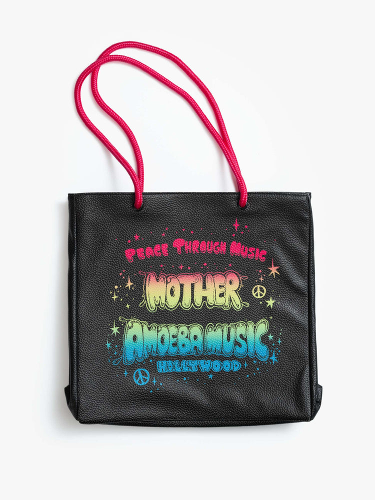 Flat view of a black faux leather with hot pink straps, the tote features a colorful Amoeba Music graphic and MOTHER's name in rainbow font.