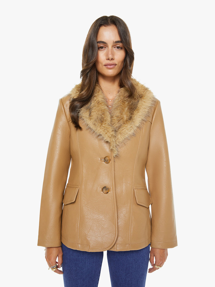 Front view of a woman in a caramel color with faux fur trim at the collar V-neck jacket features front patch pockets, buttons down the front and a tailored fit.