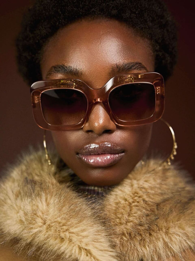 Styled view of a woman in a caramel color with faux fur trim at the collar V-neck jacket features front patch pockets, buttons down the front and a tailored fit.