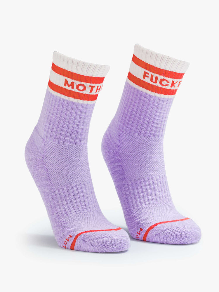 Flat view of lavender and white with red lettering details socks on a model feet.