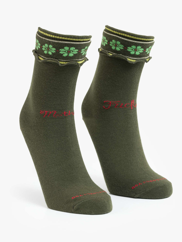 Flat view of forest green with lime-green flowers socks with yellow and white stripes and text in red across the front.