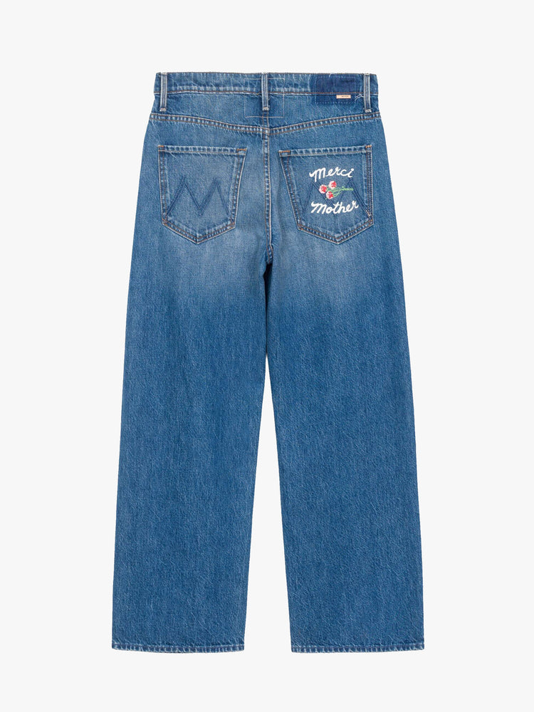 Flat view of a woman in a medium blue wide-leg jeans are designed to sit lower on the hips with a zip fly and a clean ankle-length inseam. 