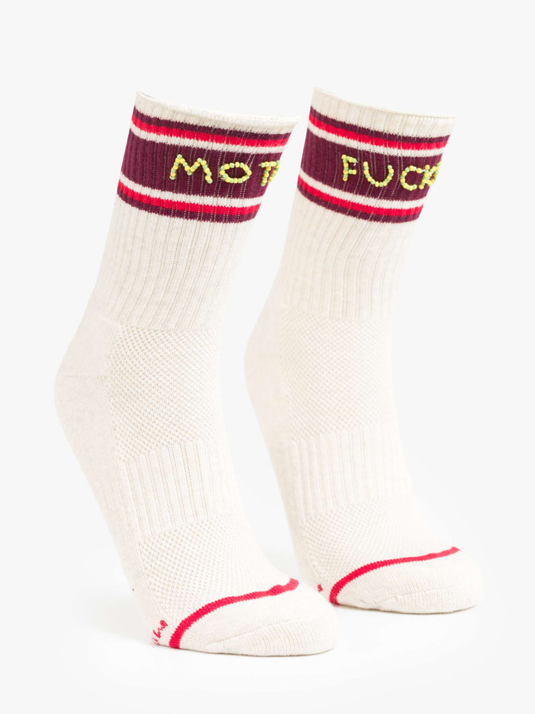 Side angle view of tube socks in cream with burgundy and red stripes and an explicit message from MOTHER spelled out in yellow and green beads.