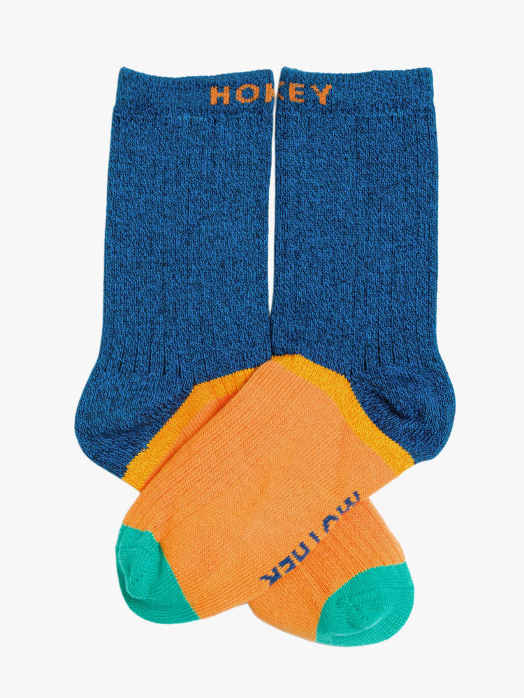 Flat view of Hokey Pokey a pair of navy, orange and teal tube socks with text across the top.