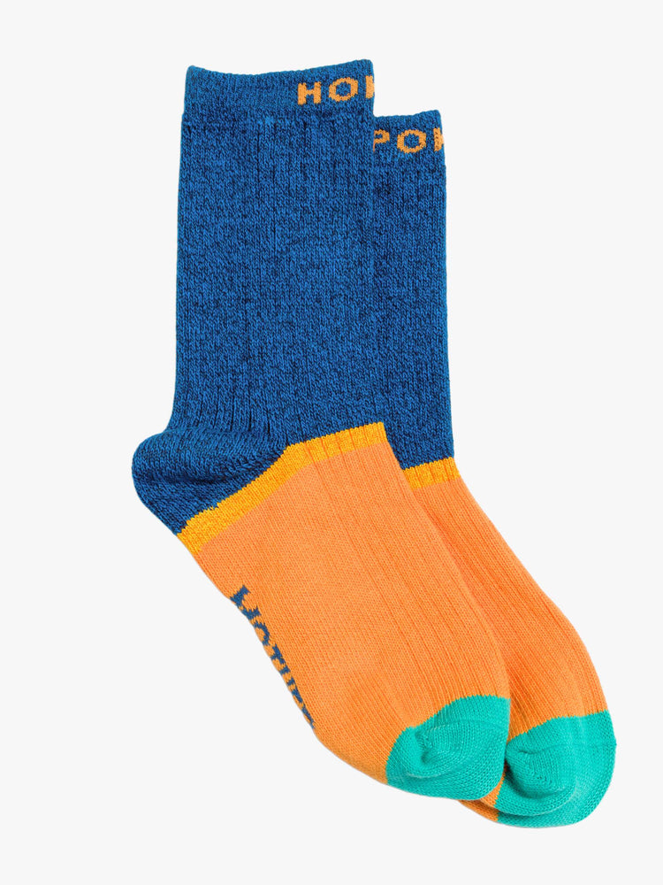 Flat view of Hokey Pokey a pair of navy, orange and teal tube socks with text across the top.