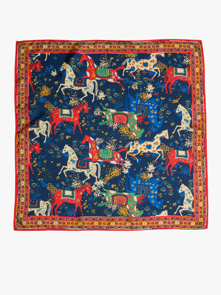Flat view square scarf made from 100% silk in navy blue with a folk art-inspired horse print and orange trim.