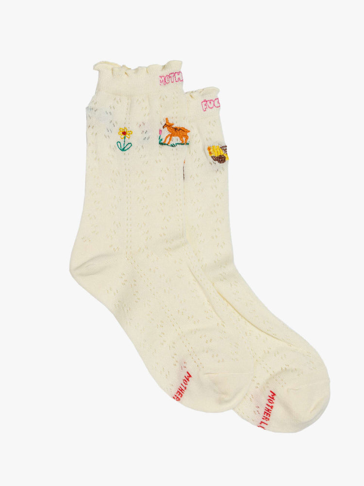 Flats view of white  tube socks with a message from MOTHER with colorful embroidery throughout.