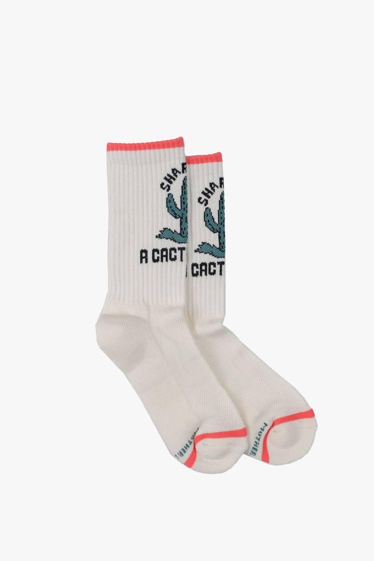 Side flat view classic tube socks in white with black lettering, peach trim and a green cactus graphic on the front.