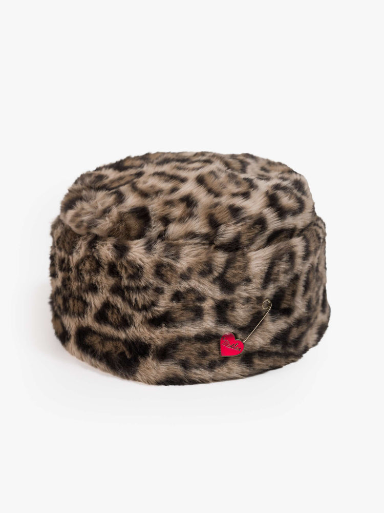 Flat of a hat with a wide folded brim and a decorative gold-toned pin with a pink heart.