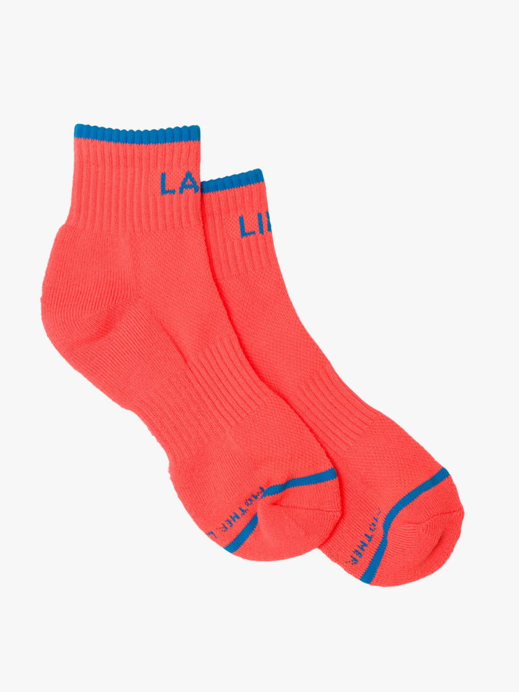 Flat view ankle-length tube socks designed in neon orange with blue text and details.