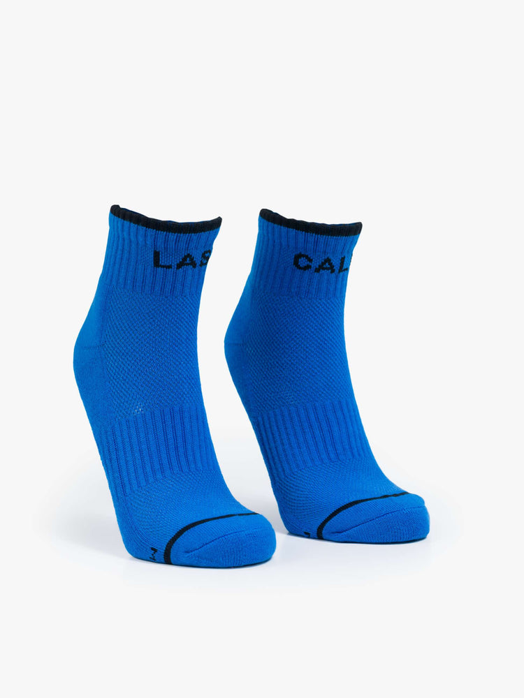 Flat of ankle-length tube socks in blue with black text and details.