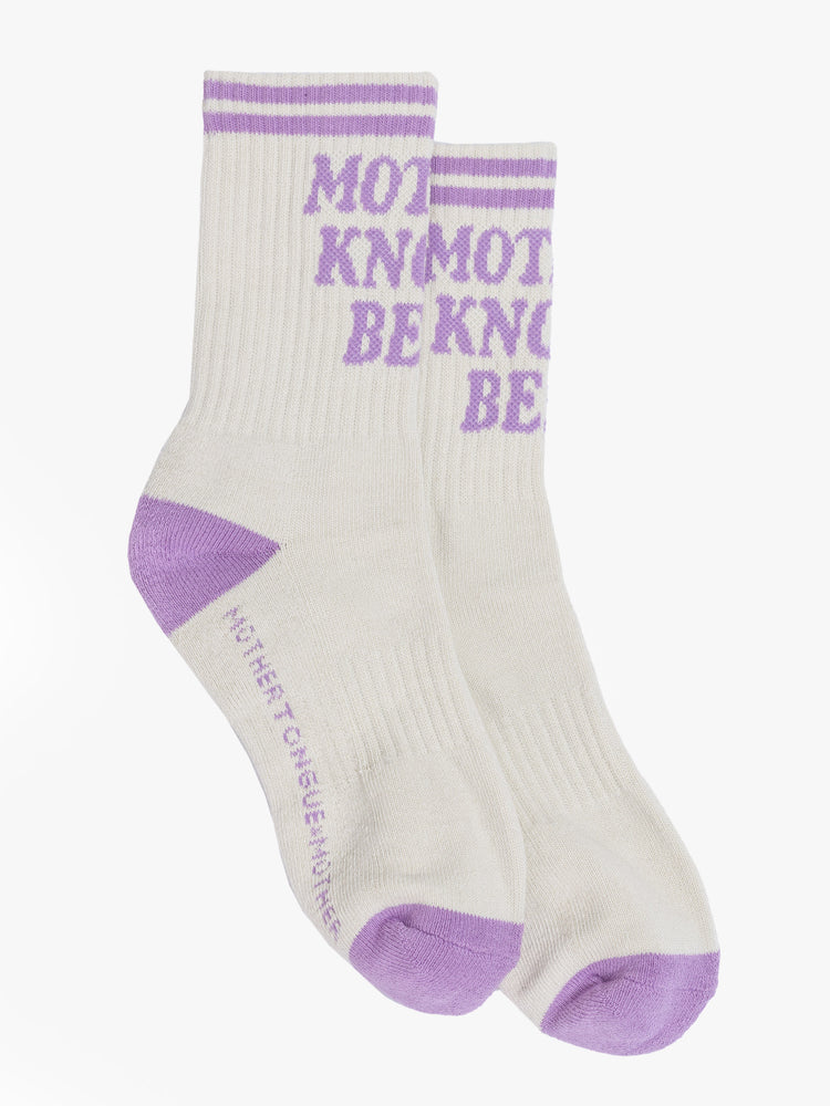 Flat side view of a vintage tube sock in cream with lavender lettering.