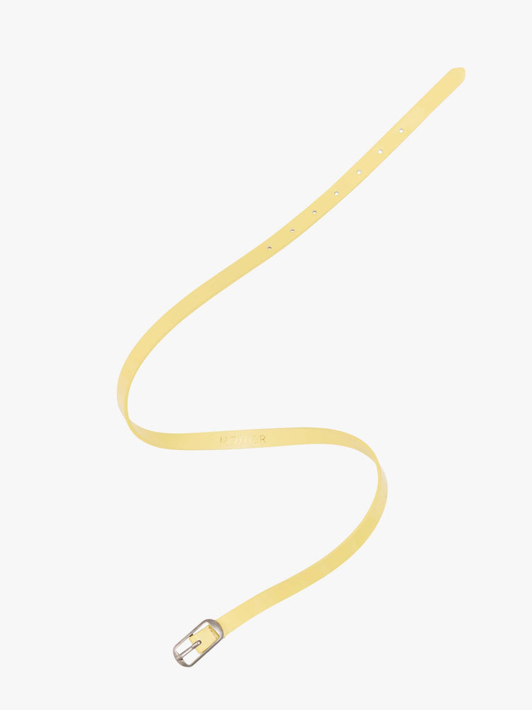 Flat view of a narrow belt is made from 100% leather with a pastel yellow coating and silver hardware.