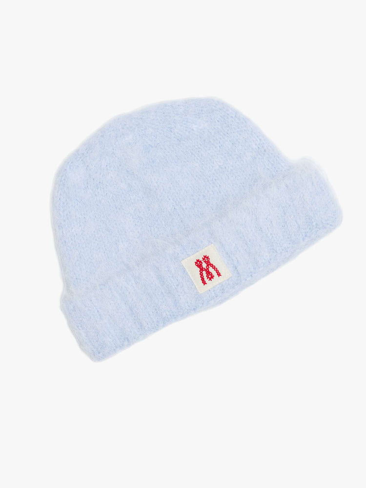 Flat view of a blue with an M patch on the front ribbed beanie with a folded hem and cozy fit.