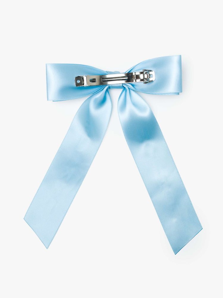 Back light blue satin-feel hair bow that looks sweet but says otherwise—with MOTHER on one tail and FUCKER on the other.