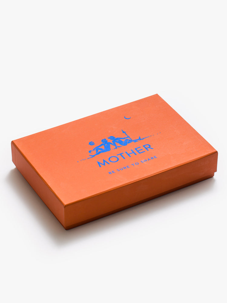 Flat of an orange rectangular box with a printed graphic reading "MOTHER".
